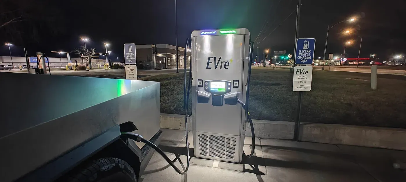 EVre fast charger in Kirksville at night with a truck charging