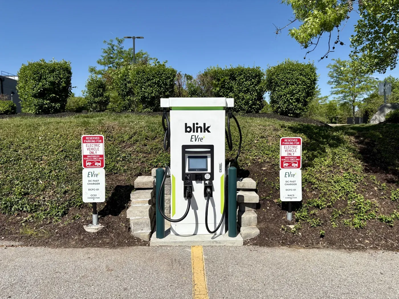 EVre Blink DC fast charger at Olympic Oaks Village with CCS1 and NACS connector signage